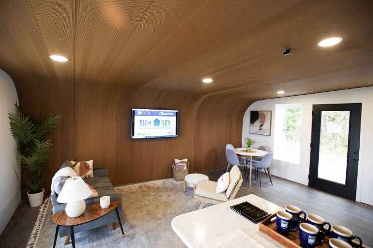 The inside of the University of Maine's first 3D printed home is visible on Oct. 12, 2023, in Orono, Maine. The printer that created the house can cut construction time and labor. An even larger printer unveiled on Tuesday, April 23, 2024, may one day create entire neighborhoods. (AP Photo/Kevin Bennett) 