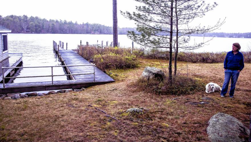 Laura Prichard near the boathouse and dock area on the shore of the Keewaydin area of Lake Winnipasaukee. The former lake community dock was destroyed in a boat accident last year.