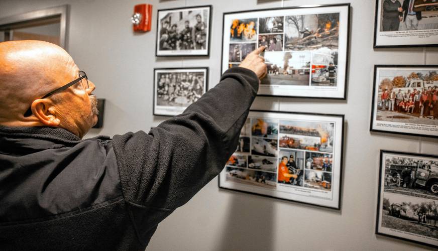 Dennis Comeau looks over some of the historic fires in Bow’s history at the central fire station. 