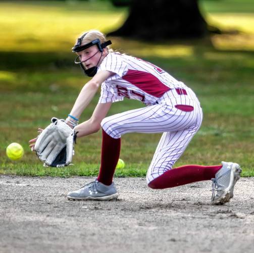 ABOVE: Concord Little League first baseman Brielle Pouliot plays a short hop during the team practice at Rollins Park on Tuesday.