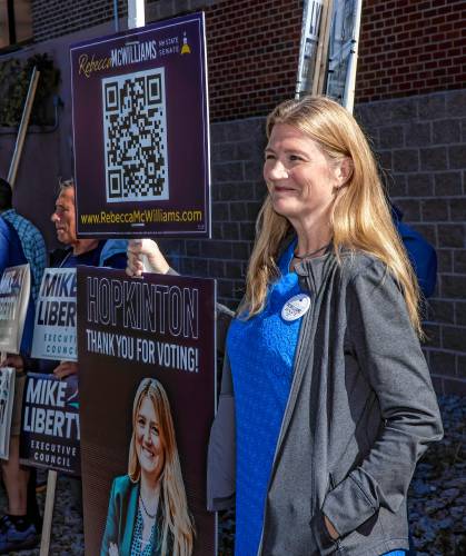 LEFT: Candidate Rebecca McWilliams of Concord stands in the line outside the polling place at Hopkinton High School on Tuesday morning.