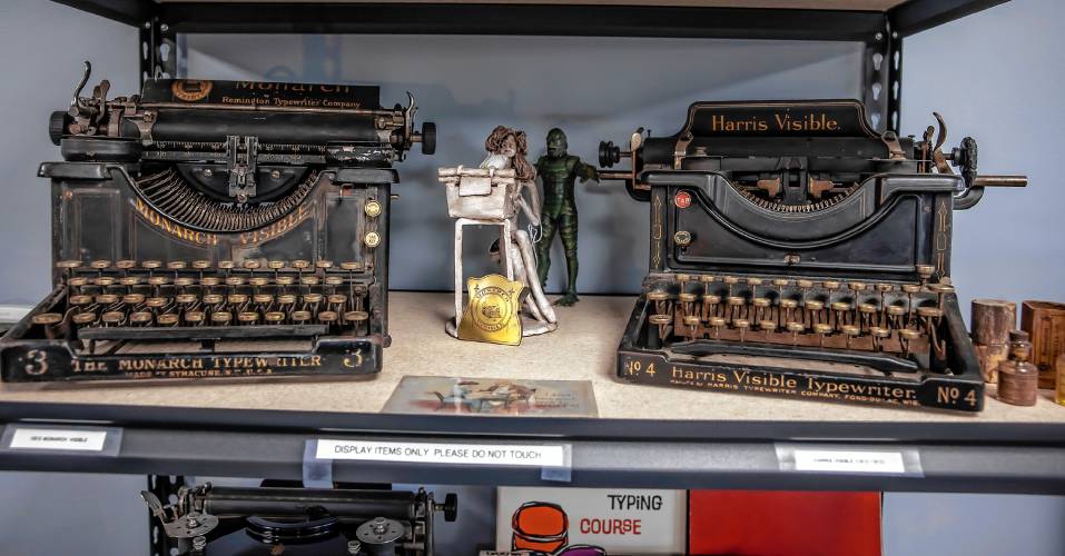 Two old manual typewriters--Remington (left) and a Harris Visible--sit on a display case at New England Typewriter in Merrimack.
