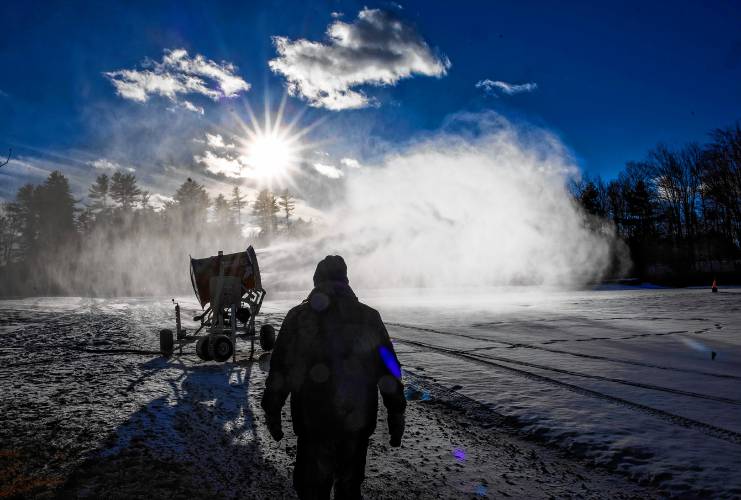 Concord Parks and Recreation Director David Gill walks toward the snowmaking fan that is making snow on the Beaver Meadow driving range as it makes a test run on Friday, December 6, 2024. Gill was on hand to make sure the equipment worked properly during the run.