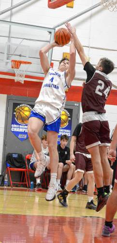 Concord Christian Academy’s Isaac Kirby (4) goes up for a shot as Littleton’s Ryan Mahy (24) attacks to block it during the Division IV boys’ basketball semifinal at Laconia High School on Monday. Kirby scored 10 points, but No. 2 Concord Christian fell to No. 3 Littleton, 64-51, CCA’s first loss of the season.