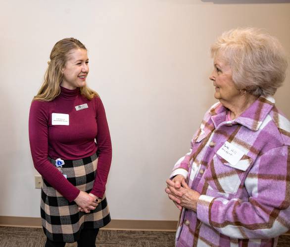 Bette Hill talks with Emily Boisvert of New Hampshire Housing at the Penacook Landing opening on Canal Street in downtown Penacook on Wednesday, April 3, 2024.