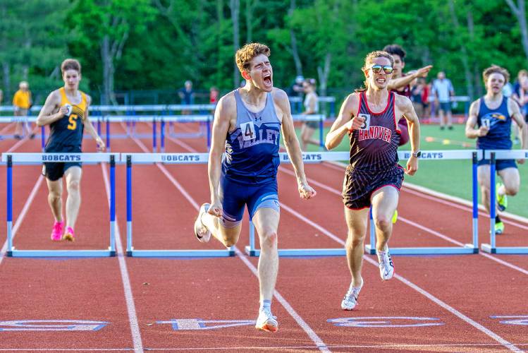 Merrimack Valley’s Mychal Reynolds (center) celebrates after crossing the finish line to claim the division title in the 300-meter hurdles at the NHIAA Division II championship on Friday at Oyster River High School in Durham. Reynolds finished the race in 41.14 seconds and also finished third in the 110 hurdles.