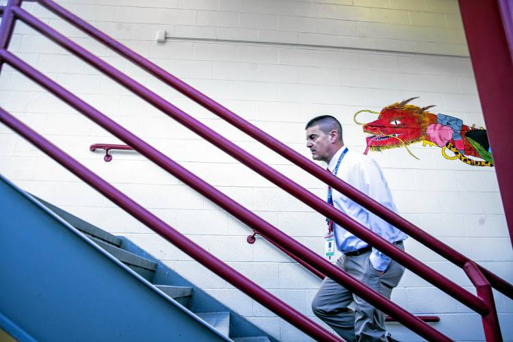 Principal Jay Richard walks up a staircase inside Rundlett Middle School, which was built in 1957. He works with maintenance staff to keep the building usable. But for those inside Rundlett, a new school can’t come soon enough. 