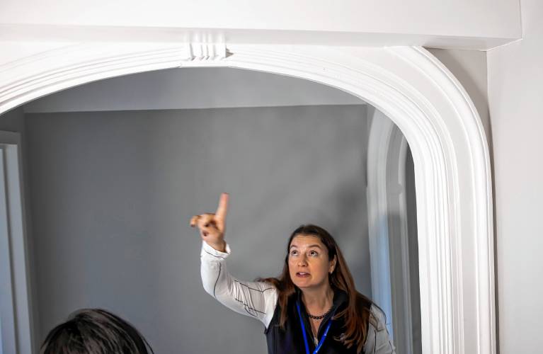 Sarah Gagnon, vice president for clinical operations for Riverbend, shows how they kept some molding when they renovated the 12-bed facility on Pleasant Street.