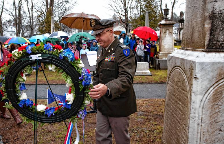 Col. Richard Oberman, medical commander and deputy director of Joint Staff at New Hampshire Army National Guard, moves the wreath onto the gravesite of President Franklin Pierce at the Old North Cemetery in Concord on Tuesday.