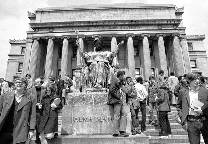 Columbia University students stand by the hooded statue of the Alma Mater after a rally in front of the low library in New York April 23, 1969. About 500 students massed quietly to demonstrate their support for the student Afro-American society’s demands concerning a Black studies program and other issues. Columbia University students stand by the hooded statue of the Alma Mater after a rally in front of the low library in New York April 23, 1969. About 500 students massed quietly to demonstrate their support for the student Afro-American society’s demands concerning a Black studies program and other issues.