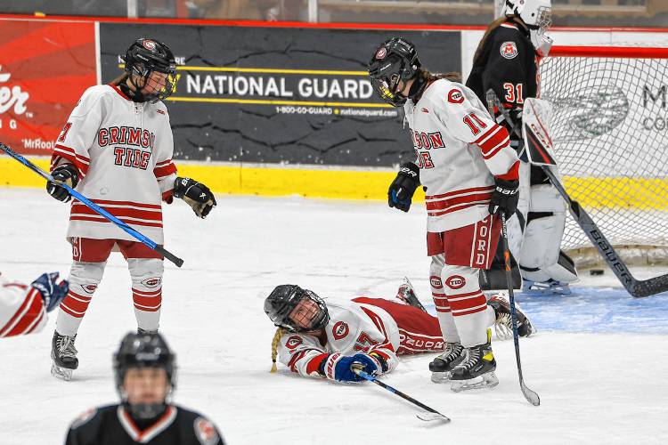 Senior forward Claire Brown (center) looks up at teammates from a prone position after netting one of her three goals in Wednesday’s win over Berlin-Gorham-Kennett.