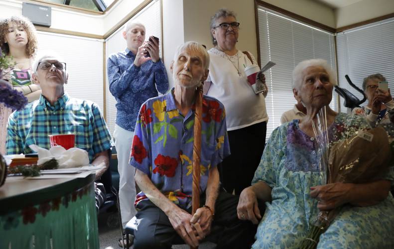 In this May 10, 2019, photo, Robert Fuller, center, leans on his walking stick and closes his eyes as he listens to music at a party in his honor in Seattle. He later became one of the hundreds of people who have used Washington's Death with Dignity Act to end their lives in the decade since it became law. (AP Photo/Elaine Thompson) In this May 10, 2019, photo, Robert Fuller, center, leans on his walking stick and closes his eyes as he listens to music at a party in his honor in Seattle. He later became one of the hundreds of people who have used Washington's Death with Dignity Act to end their lives in the decade since it became law. (AP Photo/Elaine Thompson)