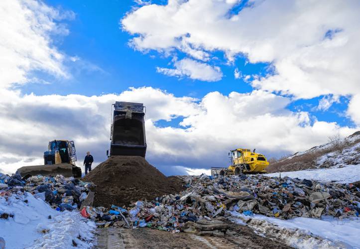 Conway public works staffer Tim Shackford oversees the pouring of dirt over the garbage dumped the in the city landfill on Wednesday, January 18, 2023.