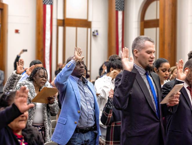 Kayitani Ndutiye gets sworn in as a United States citizen last Friday in a ceremony at the federal court in Concord, days before the New Hampshire primary.