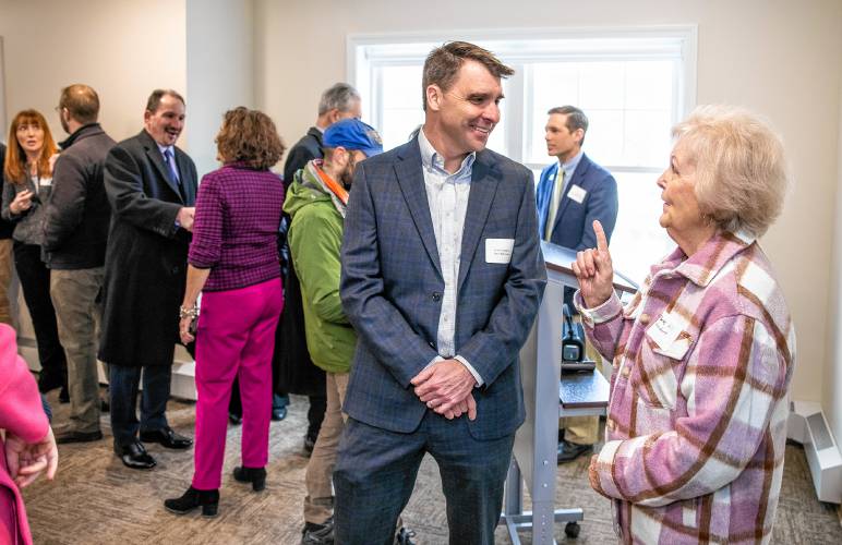 Bette Hill talks with Brian Gallagher of the Caleb Group, which owns and manages  Penacook Landing on Canal Street in downtown Penacook on Wednesday, April 3.