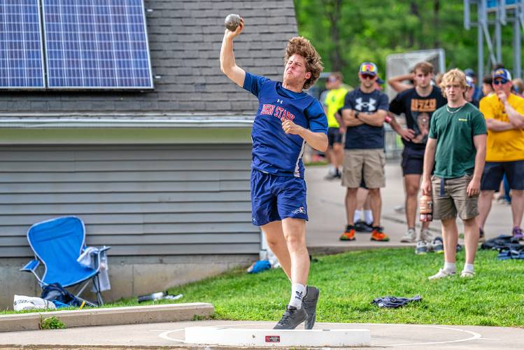 John Stark’s Joel Douzanis tosses the shot put at the NHIAA Division II championship on Friday at Oyster River High School in Durham. Douzanis won the event with a throw of 48 feet, 5 inches.