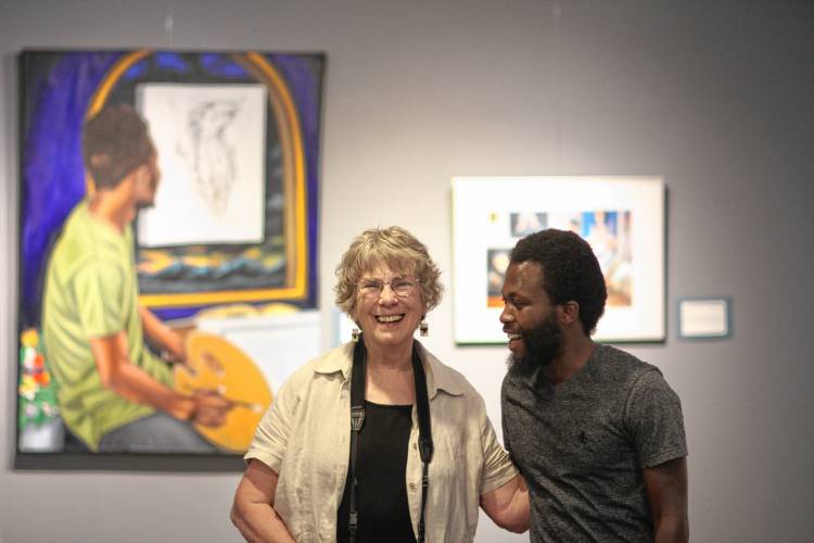 Concord photographer Becky Field with Congolese painter Jozimar Matimano at their joint exhibit in Portsmouth.