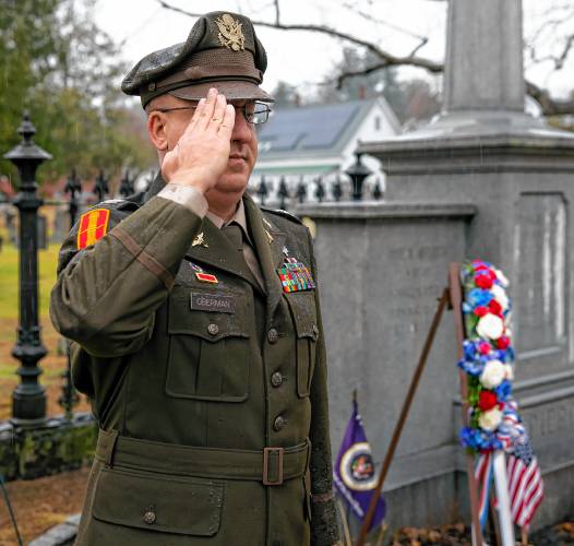 Col. Richard Oberman, medical commander and deputy director of Joint Staff at New Hampshire Army National Guard, salutes during taps at the gravesite of President Franklin Pierce at the Old North Cemetery in Concord on Tuesday.