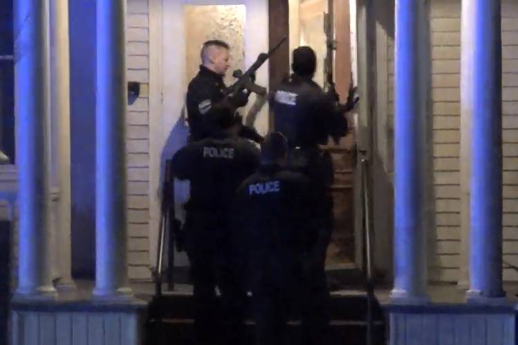In a still frame from video law enforcement officers enter a home, Saturday, Nov. 25, 2023, in Burlington, Vt., while pursuing a suspect in the shooing of three young men. Burlington Police Department arrested Jason J. Eaton, suspected in the shooting of three young men of Palestinian descent, who were attending a Thanksgiving holiday gathering near the University of Vermont campus Saturday evening. (Wayne Savage via AP)