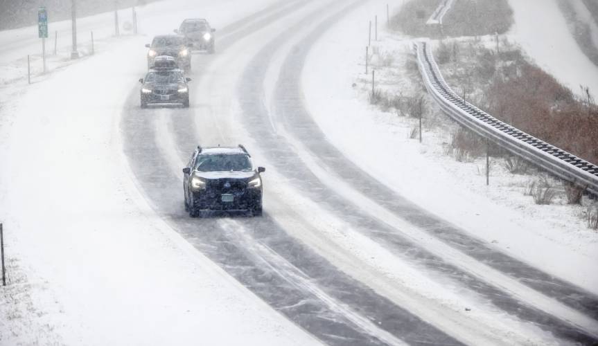 TOP: Cars make their way up I-93 northbound between exit 15 and 16 during the Tuesday storm.