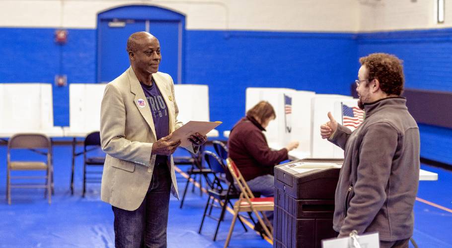 Kayitani Ndutiye gets the thumbs up from Ward 4 poll worker Gregory Negals at the Green Street Community Center in Concord after voting for the first time in the New Hampshire Primary on Jan. 23.