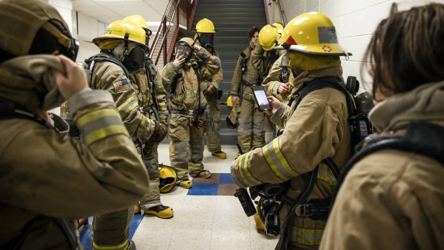 CRTC firefighter students put on their darkened masks to simulate smoky situations before working through an obstacle course on Thursday, March 7, 2024 at Concord High School.