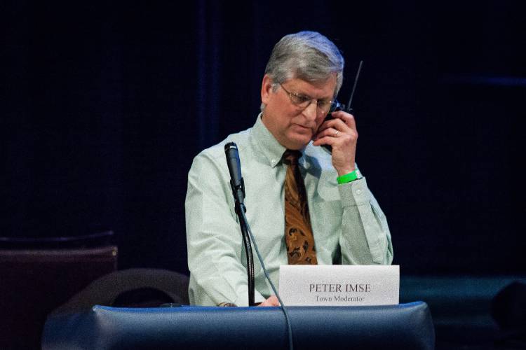 Town moderator Peter Imse uses a radio to communicate with an overflow crowd in 2015. Town moderator Peter Imse uses a radio to communicate with an overflow crowd in 2015.