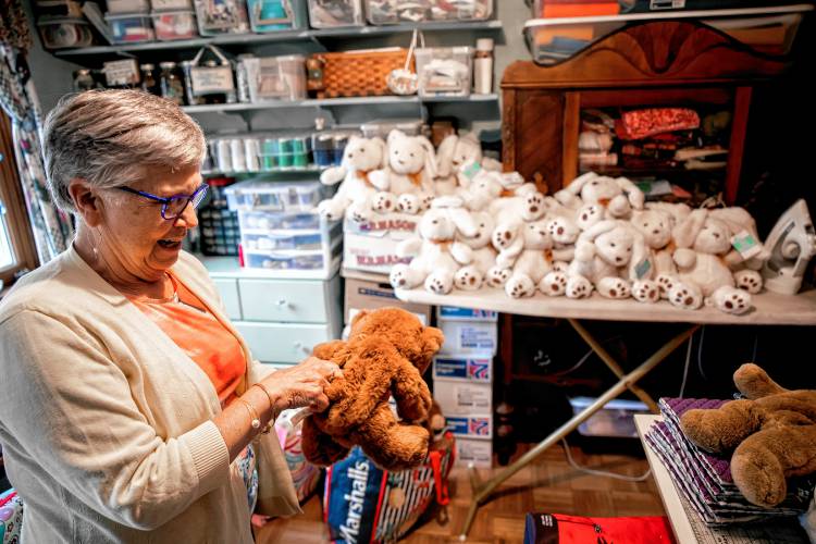 Nancy Peperissa in her sewing room in her Penacook home where she puts the finishing touches on making skull caps for chemotherapy patients and filling teddy bears with rice to comfort Alzheimer patients.