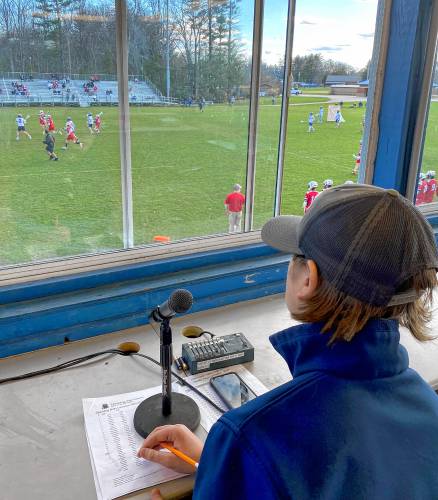 Merrimack Valley sophomore Nick Gelinas in the tower above the main athletic field where he announces the starting lineups before the game and the touchdown and goal scorers during the action as the public address announcer.