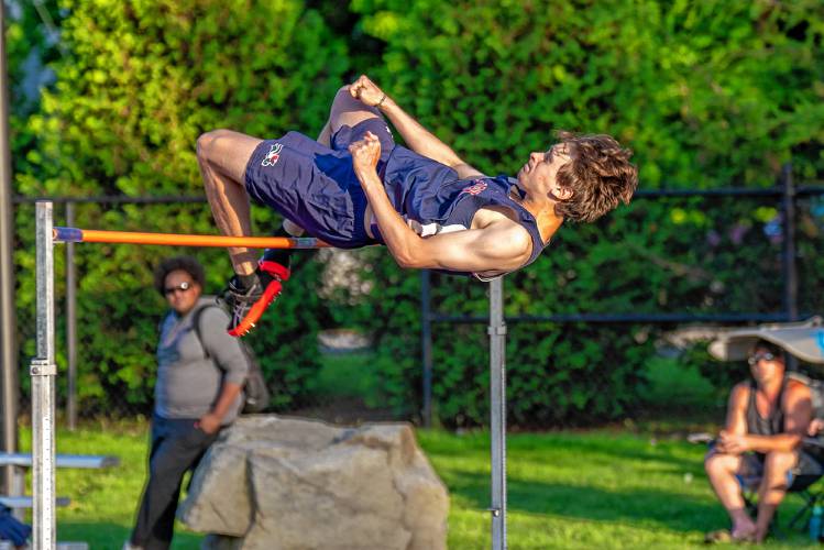 John Stark’s Sam Kinsey-Turner clears the bar while competing in the high jump at the NHIAA Division II championship on Friday at Oyster River High School in Durham. Smith-Turner cleared 6 feet, 2 inches to win the title.