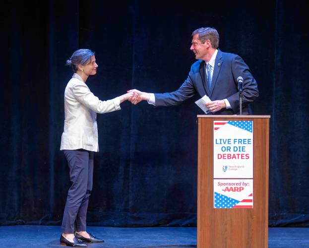 Democratic congressional candidates Maggie Goodlander (left) and Colin Van Ostern shake hands after the Live Free of Die Debates at the Rosamond Page Putnam Center for the Performing Arts on the campus of New England College in Henniker, New Hampshire on Wednesday evening, September 4, 2024. The primary for the CD2 seat is set for September 10, 2024.