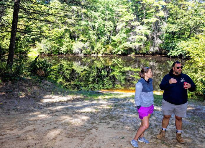 Suncook River Campâs new owners Joe and Kim Caprio in front of one of the two beaches that lead down to the Suncook River.