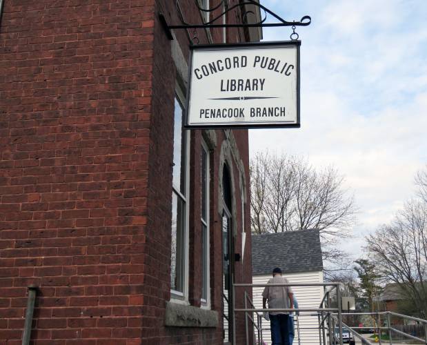 Patrons are shown leaving the Concord Library's Penacook branch on May 5, 2018.