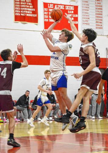 Concord Christian Academy’s Jaden Young (14) takes a shot during the Division IV boys’ basketball semifinal at Laconia High School on Monday. No. 2 Concord Christian fell to No. 3 Littleton, 64-51, CCA’s first loss of the season. 