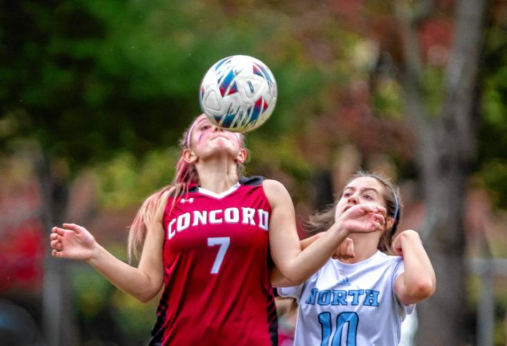 Concord defenseman Willa Marino battles for the ball with Nashua North midfielder Mary Pappas during the first half at Memorial field on Wednesday, October 25, 2023.