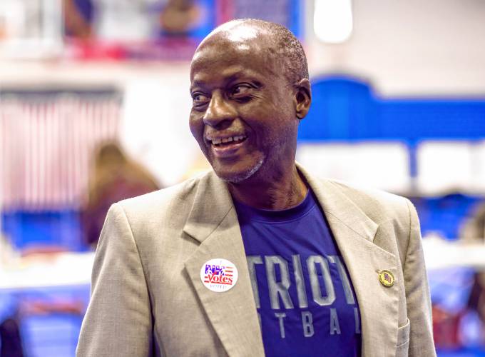 Kayitani Ndutiye reacts after voting for the first time in the New Hampshire primary on Tuesday, Jan. 23, days after being sworn in as a United States citizen just last Friday.