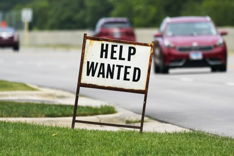 A help-wanted sign is displayed at a gas station in Mount Prospect, Ill., in 2021.