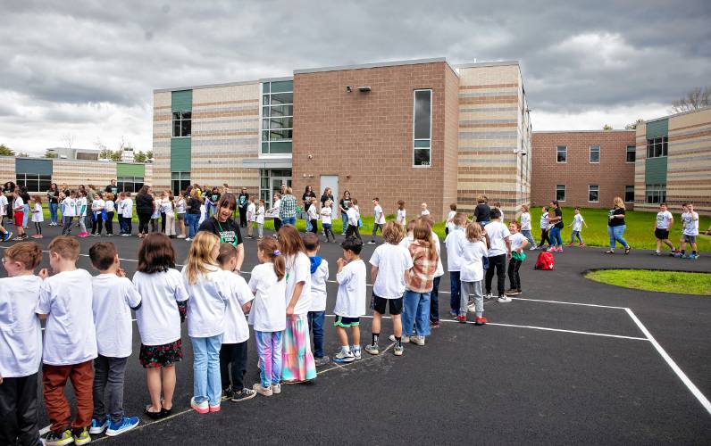 LEFT: Allenstown Community School students and faculty gather for a drone photo outside the school on the first day of classes at the new facility. Faculty wore black tee shirts commemorating the first day of school and the students wore white tee shirts given by a school employee.