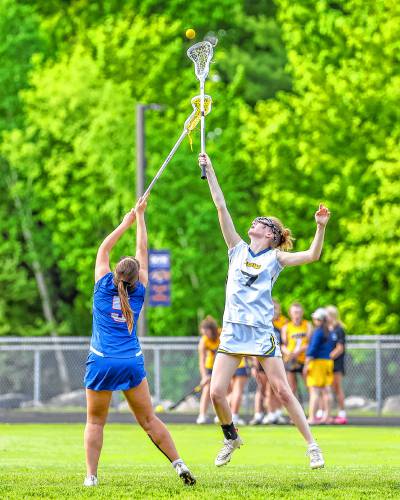 Bow's Kylie McKee leaps in the air for a draw control during Bow's 11-10 overtime win over Londonderry on Thursday, May 23, 2024.
