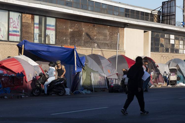 FILE - The tents of a homeless camp line the sidewalk in area commonly known as Mass and Cass, Saturday, Oct. 23, 2021, in Boston. FILE - The tents of a homeless camp line the sidewalk in area commonly known as Mass and Cass, Saturday, Oct. 23, 2021, in Boston.