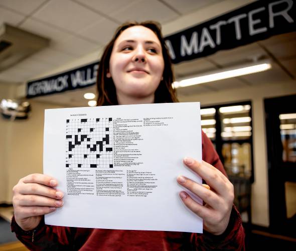 Merrimack Valley High School senior Natalie DeGreenia holds up one of her crossword puzzles she has created for her senior project on Wednesday, April 3, 2024 in the foyer of the school.