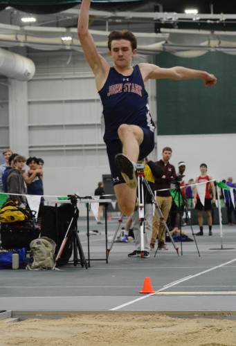 John Stark’s Rio Calle competes in the long jump at the NHIAA Division II indoor track and field championship on Saturday at Plymouth State University. Calle set a personal record in the high jump to win the event at 6 feet, 4 inches and finished second in the long jump to lead John Stark to third place.