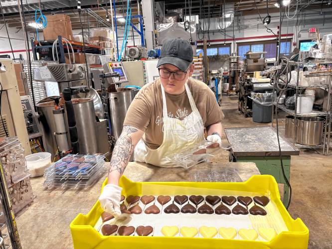 Chocolatier Kate Hayden creates chocolate heart pops for Valentine's Day at Granite State Candy Shoppe.