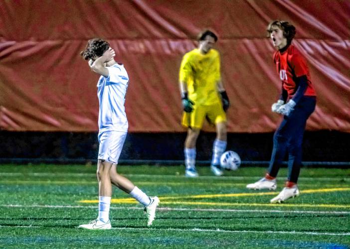 Hopkinton midfielder Fin Murphy (left) reacts after Campbell goalkeeper Jack Bourque (right) saved his penalty kick on Monday evening, October 30, 2023 during the D-III semifinals at Laconia High School.