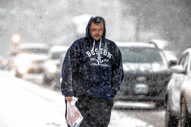 Al True walks along Route 3 in Tilton on the way back from the store on Tuesday.