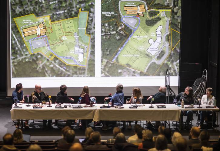 The Concord School Board looks up at the two site plans for the Rundlett Middle School at the opening of the meeting on Wednesday, Dec. 6, 2023. The board voted to build the new school on the Broken Ground School site.