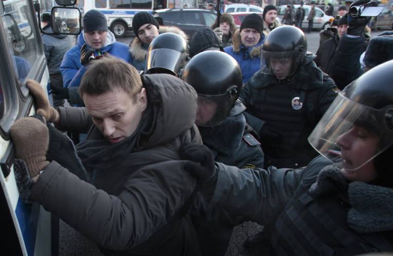 FILE - Police officers detain opposition leader Alexei Navalny during an unauthorized rally in Lubyanka Square in Moscow, Russia on Dec. 15, 2012. Alexei Navalny, the fiercest foe of Russian President Vladimir Putin who crusaded against official corruption and staged massive anti-Kremlin protests, died in prison Friday Feb. 16, 2024 Russia’s prison agency said. He was 47. (AP Photo/Pavel Golovkin, File)