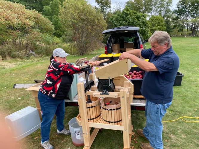 Darryl Peasely, a leader of the Abenaki helping Abenaki, hand presses the apples collected from local farms to make cider.