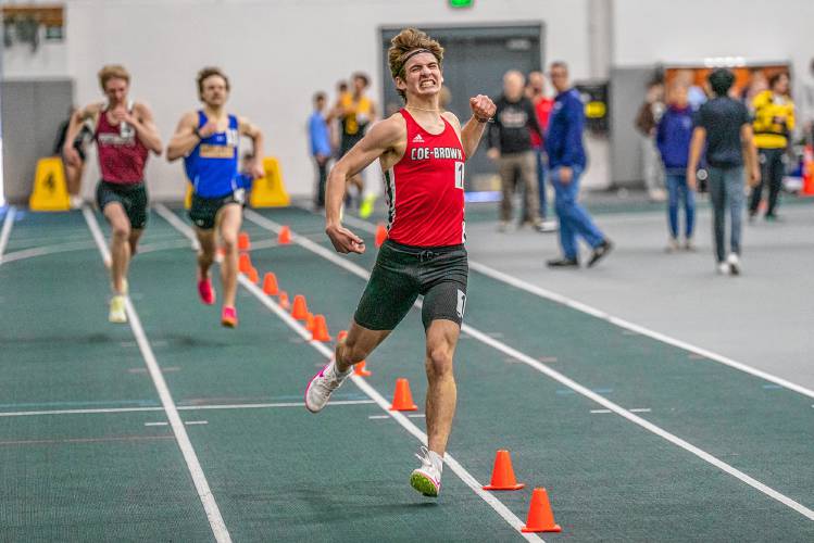 Coe-Brown’s Jamie Lano pumps his fist in celebration as he crosses the line to win the 1,500-meter title at the NHIAA Division II indoor track & field championships on Feb. 11 at Plymouth State. Lano also won the 3,000 and finished second in the 1,000 to lead Coe-Brown to back-to-back team titles.