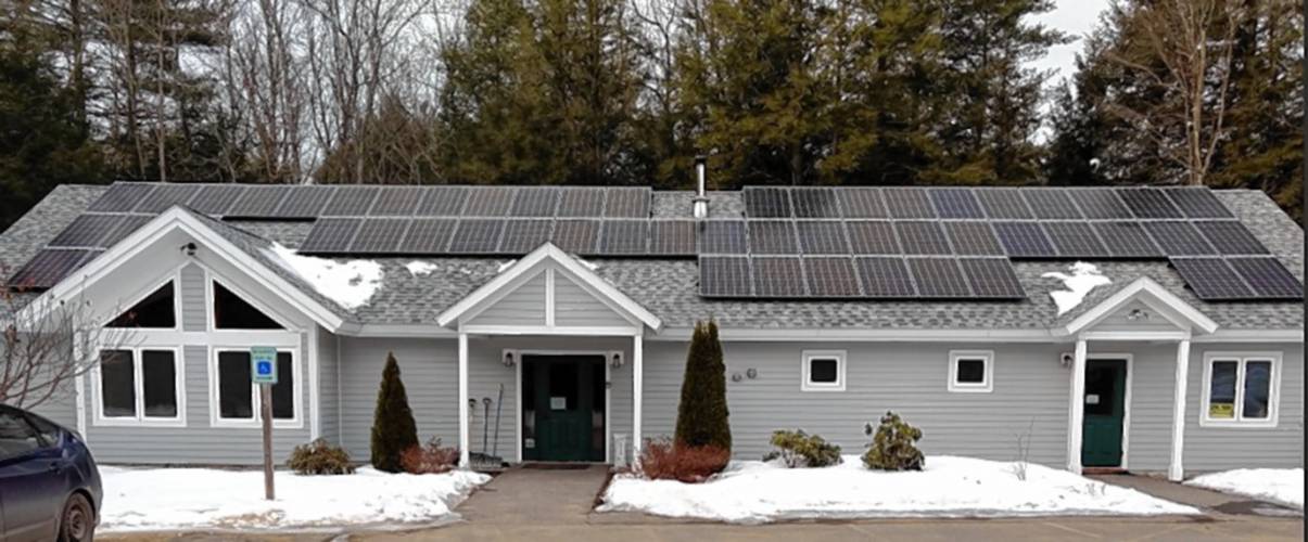 The Concord Quaker meetinghouse in Canterbury, with 16 kW of solar panels on the roof. The building has also added geothermal heat.